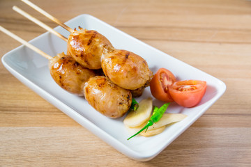 Grilled sausages on wooden board