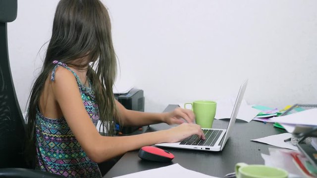 the girl poured tea on the laptop. doing homework, online learning, 4k close-ups,