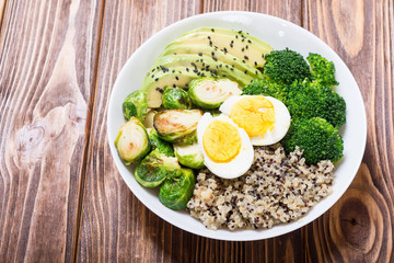 Buddha bowl with quinoa , eggs , avocado , brussels sprouts and broccoli