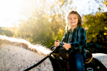 Fototapeta na wymiar in a beautiful Autumn season of a young girl and horse
