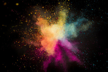 Colored powder explosion on black background.