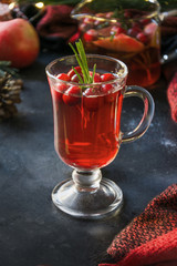 Christmas cranberry and apple drink garnish rosemary and fir branches on black. Close up. Xmas drink.