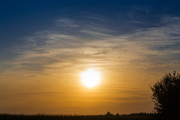 Bright multi-colored sunset through the clouds.