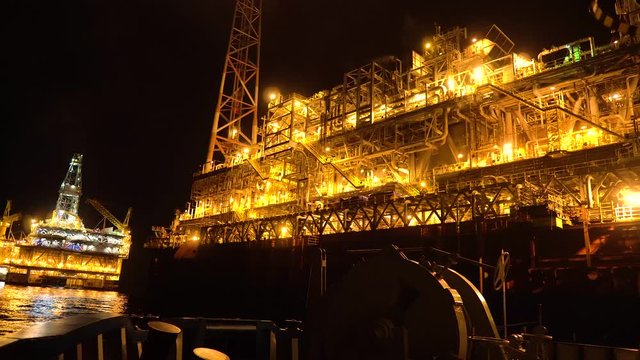 FPSO tanker vessel near Oil platform Rig. Offshore oil and gas industry, sea oil production and storage
