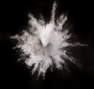 Silver powder explosion on black background.