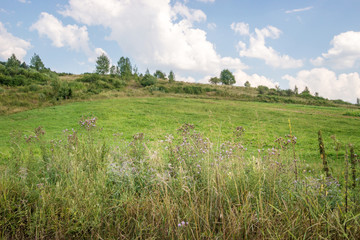 Summer landscape with field and hills in Central Europe.