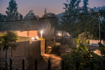Dimly lit street scene among houses in Nyamirambo, an outlying suburb of Kigali