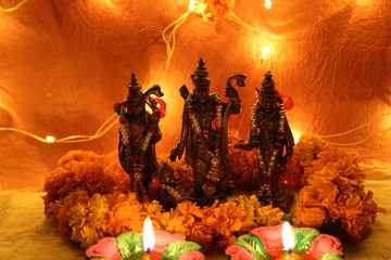 hindu god statues with flowers and diya on diwali