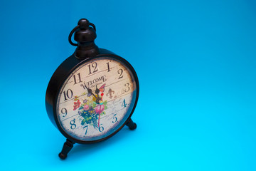 Beautiful clock close-up on a blue background.