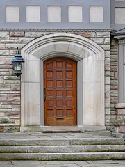 wooden door with stone frame on elegant house