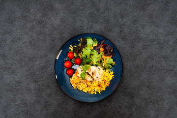 Cooked rice with vegetables, cod and lemon sauce