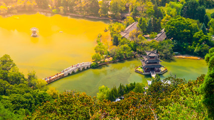 Suocui Bridge over Black Dragon Pool at Moon Embracing Pavilion in Jade Spring Park, Lijiang, China. Aerial view © pyty