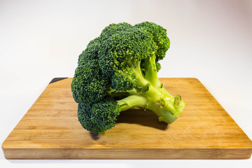 Broccoli cabbage fresh greens on a wooden board