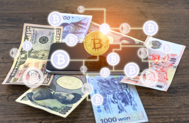 Businessman Shake hands on bitcoins and Banknotes dollars, money, won, yen. the form of digital (Cryptocurrency) an intermediary in the exchange of goods and services. Image use for business concept.