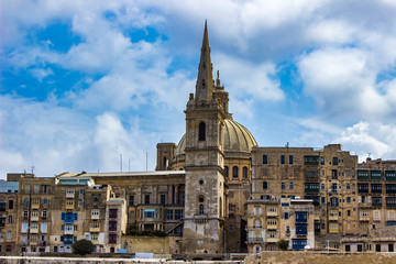 Fototapeta na wymiar Dome of Our Lady of Mount Carmel church and St Paul's Cathedral in Valletta, Malta