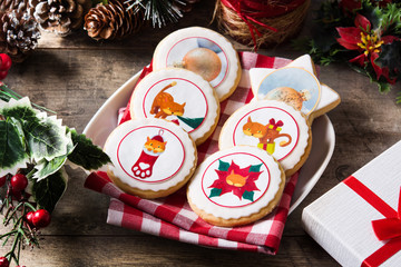 Christmas butter cookies decorated with Christmas graphics, on wooden table.

