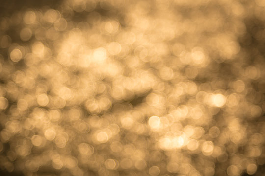 Blured of Shadow of the sun that falls on the water in the evening. Bokeh of The golden light is caused by the impact of light on the water surface in the river.Can use for abstract background.
