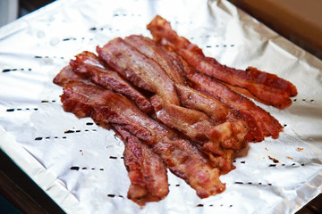 hot delicious freshly cooked grilled pork bacon ready to eat on aluminum foil. Healthy and hearty...