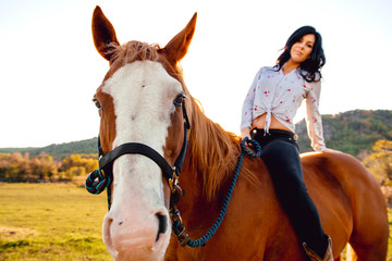 Obraz premium A Woman with her horse at sunset, autumn outdoors scene