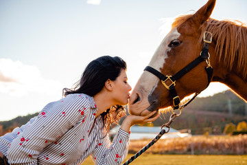 Obraz premium A Woman with her horse at sunset, autumn outdoors scene