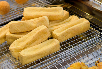 Traditional fried Tofu served with sweet chili sauce or sweet plum sauce. Famous Chinese vegetarian food cuisine.