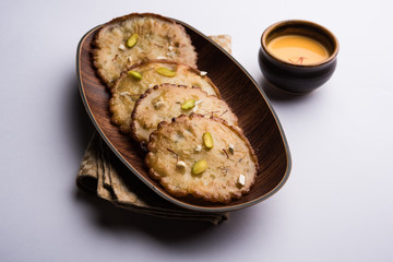 Malpua sweet - Traditional Indian dessert or pancake for festivals, served in plate with rabri/rabdi . selective focus