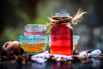 Home remedy for hair fall on wooden surface in glass bowl well mixed with ingredients as rose water, raw onion juice and honey.Close up shot or top shot.