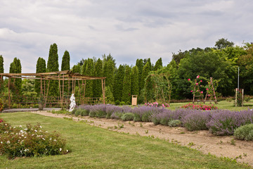 Castle garden with statue and flowers