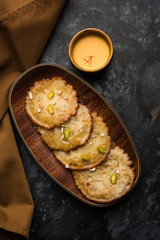Malpua sweet - Traditional Indian dessert or pancake for festivals, served in plate with rabri/rabdi . selective focus