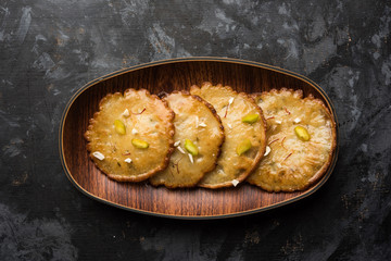 Malpua sweet - Traditional Indian dessert or pancake for festivals, served in plate with rabri/rabdi . selective focus