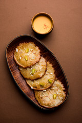 Malpua sweet - Traditional Indian dessert or pancake for festivals, served in plate with rabri/rabdi . selective focus