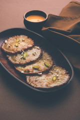 Malpua sweet - Traditional Indian dessert or pancake for festivals, served in plate with rabri/rabdi . selective focus