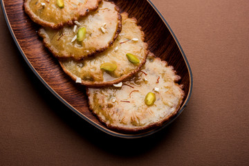 Malpua sweet - Traditional Indian dessert or pancake for festivals, served in plate with rabri/rabdi . selective focus