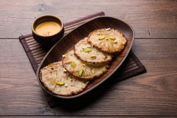 Malpua sweet - Traditional Indian dessert or pancake for festivals, served in plate with rabri/rabdi . selective focus