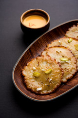 Malpua sweet - Traditional Indian dessert or pancake for festivals, served in plate with rabri/rabdi . selective focus