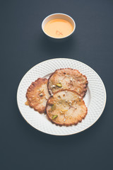Malpua sweet - Traditional Indian dessert or pancake for festivals, served in plate with rabri/rabdi . selective focus