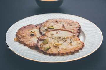 Malpua sweet - Traditional Indian dessert or pancake for festivals, served in plate with rabri/rabdi . selective focus