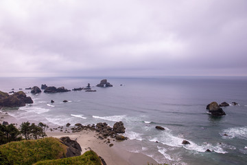 View on small bay at Ecola state park. Ecola point and Sea Lion Rock visible
