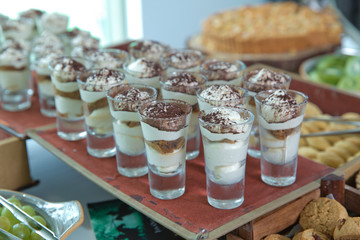 Cold cafe latte in glass. Glass of coffee cocktail with foam decorated with cinnamon powder . coffee drink with steamed milk and cinnamon .
