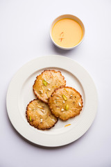Malpua sweet - Traditional Indian dessert or pancake for festivals, served in plate with rabri/rabdi . selective focus