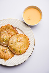 Malpua sweet - Traditional Indian dessert or pancake for festivals, served in plate with rabri/rabdi . selective focus