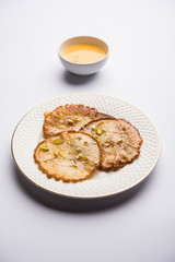Malpua sweet - Traditional Indian dessert or pancake for festivals, served in plate with rabri/rabdi . selective focus