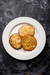 Malpua sweet - Traditional Indian dessert or pancake for festivals, served in plate with rabri/rabdi . selective focus