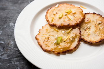 Malpua sweet - Traditional Indian dessert or pancake for festivals, served in plate with rabri/rabdi . selective focus