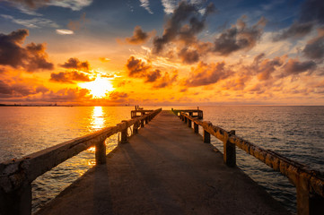 Concrete bridge to the sea with sunrise