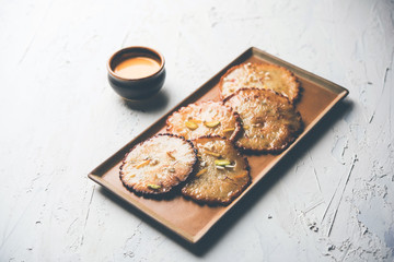 Malpua sweet - Traditional Indian dessert or pancake for festivals, served in plate with rabri/rabdi . selective focus