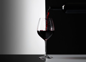 Red wine is poured into a glass.