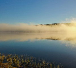 Fototapeta na wymiar Fog on Lake at sunrise 