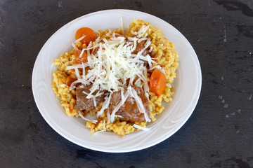 Veal in red sauce and rice with turmeric