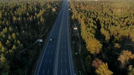 drone shot multilane road in autumn forest